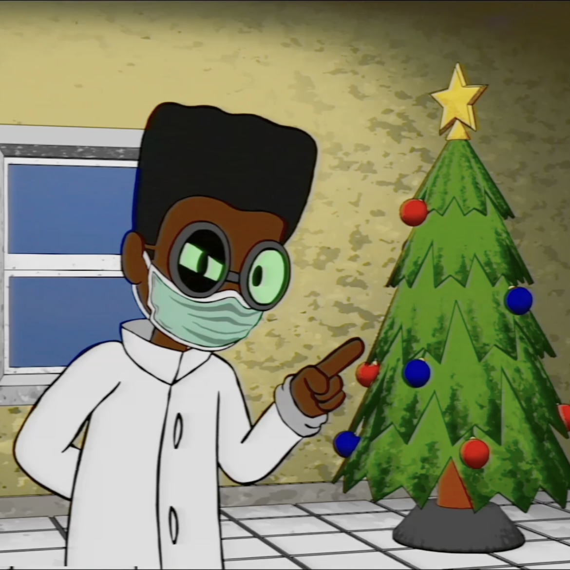 A man in a labcoat standing in front of a Christmas tree.